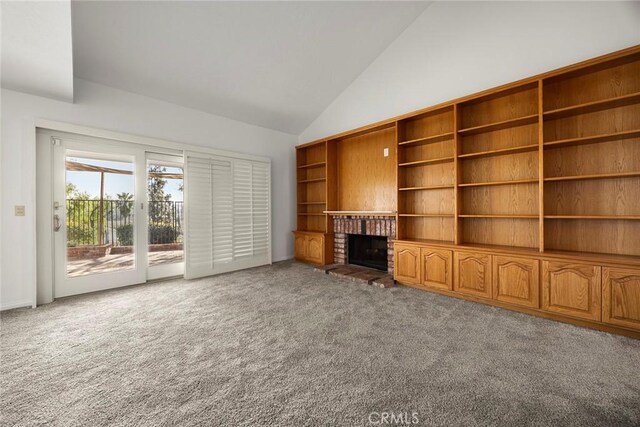 unfurnished living room featuring high vaulted ceiling, carpet flooring, and a fireplace