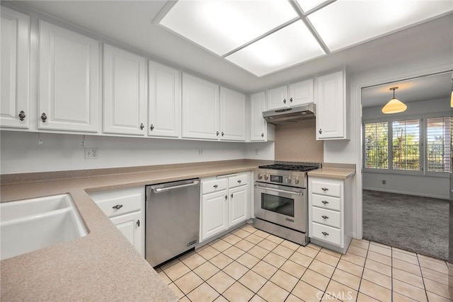 kitchen with appliances with stainless steel finishes, light countertops, white cabinets, and under cabinet range hood