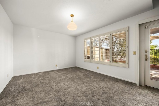 empty room with carpet floors and baseboards