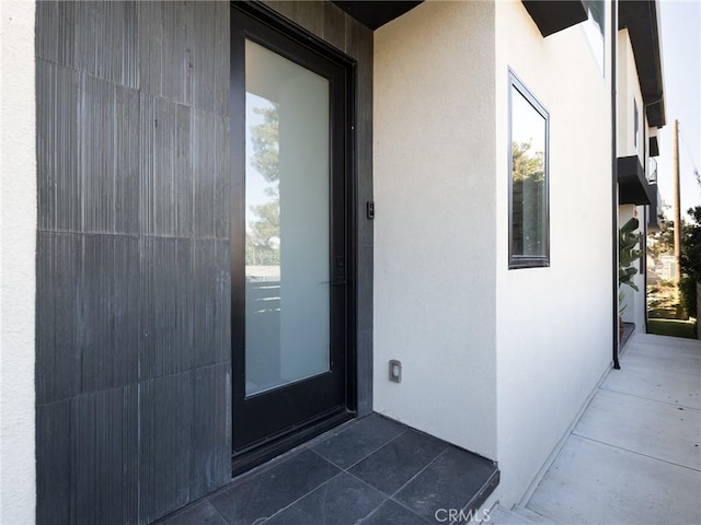 entrance to property with stucco siding