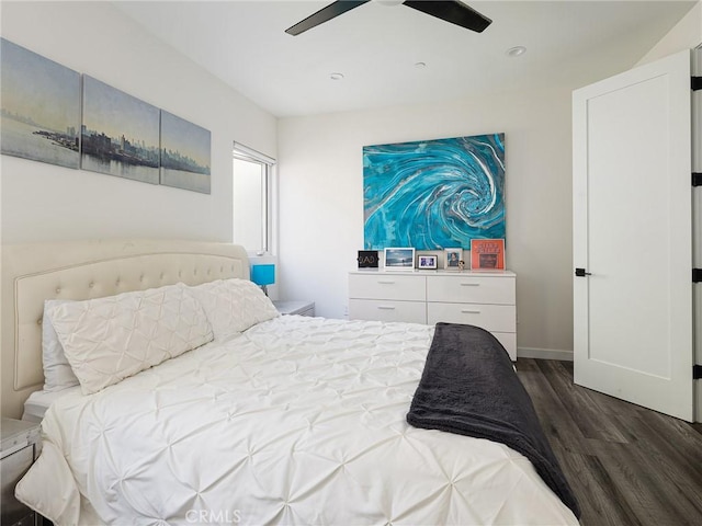 bedroom with wood finished floors, a ceiling fan, and baseboards