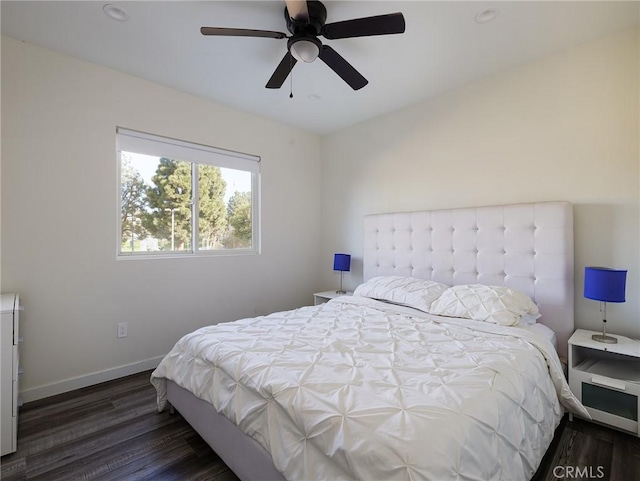 bedroom featuring a ceiling fan, baseboards, and wood finished floors