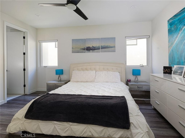 bedroom featuring dark wood-style floors, ceiling fan, and baseboards