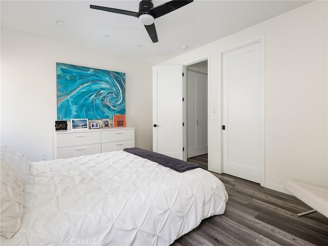 bedroom featuring ceiling fan, dark wood finished floors, and baseboards