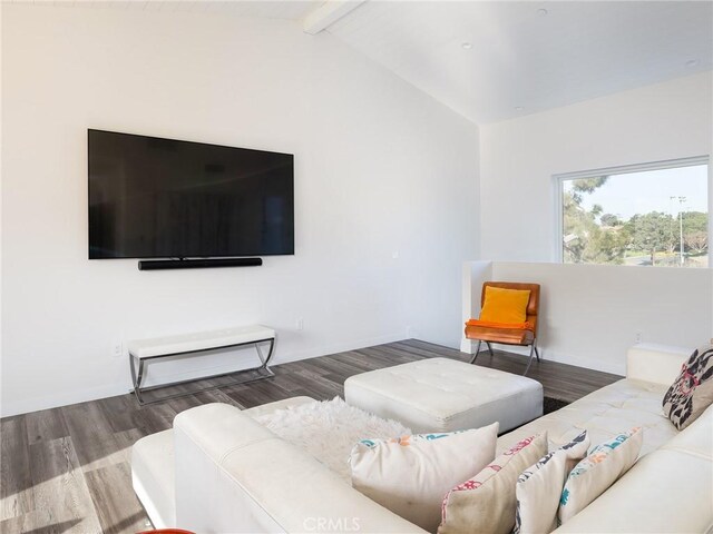 living room featuring vaulted ceiling with beams and wood finished floors