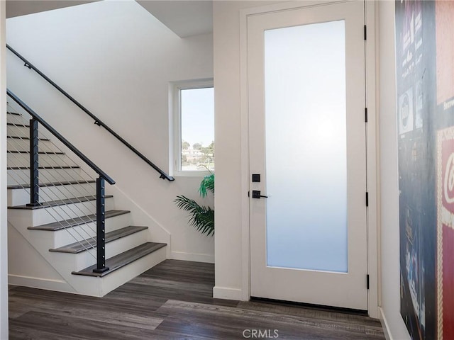 entrance foyer with stairway, wood finished floors, and baseboards