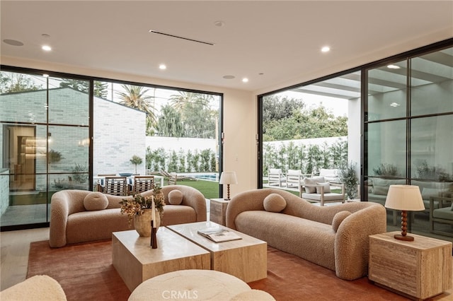 living area featuring expansive windows, wood finished floors, and recessed lighting