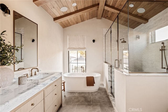 full bathroom with a shower stall, vaulted ceiling with beams, a soaking tub, and plenty of natural light