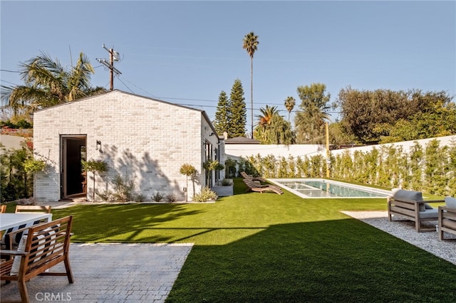 view of yard with a patio area and a fenced in pool