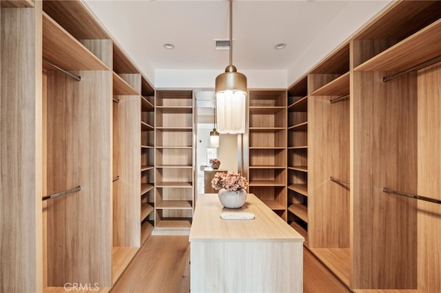 walk in closet with light wood-style flooring and visible vents