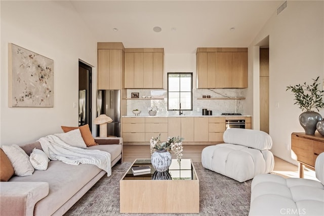 living area with wood finished floors and visible vents