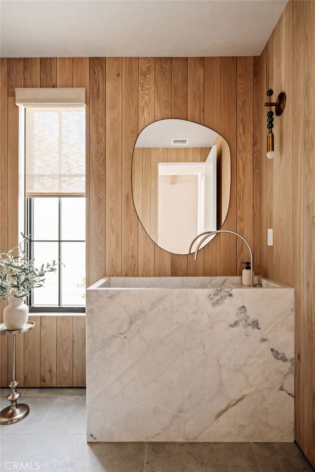 bathroom with wood walls