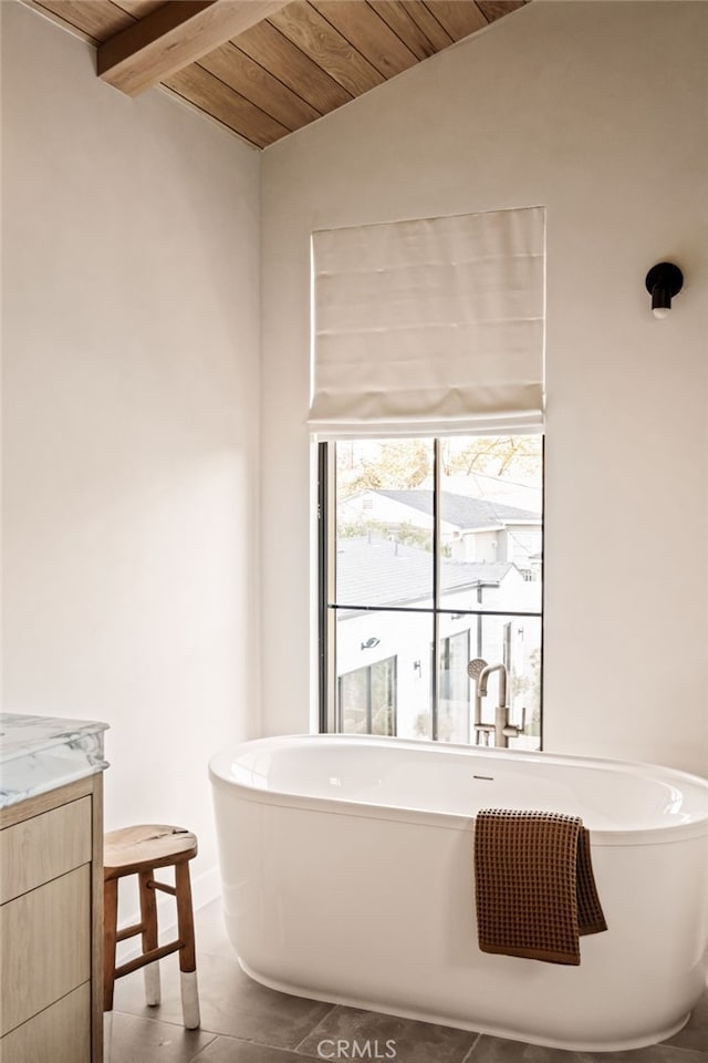 full bathroom with a soaking tub, vaulted ceiling with beams, wooden ceiling, and vanity