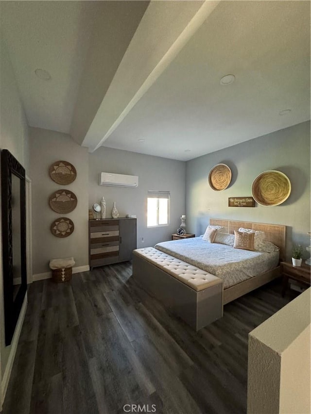 bedroom with an AC wall unit, wood finished floors, and baseboards