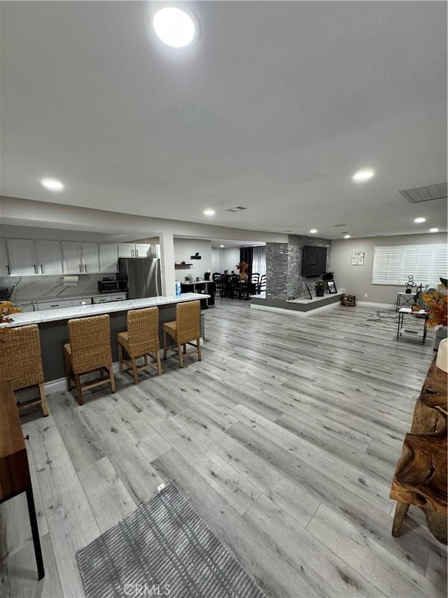 misc room featuring recessed lighting, baseboards, visible vents, and light wood finished floors