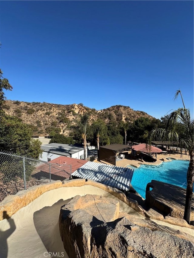 view of pool featuring fence and a mountain view