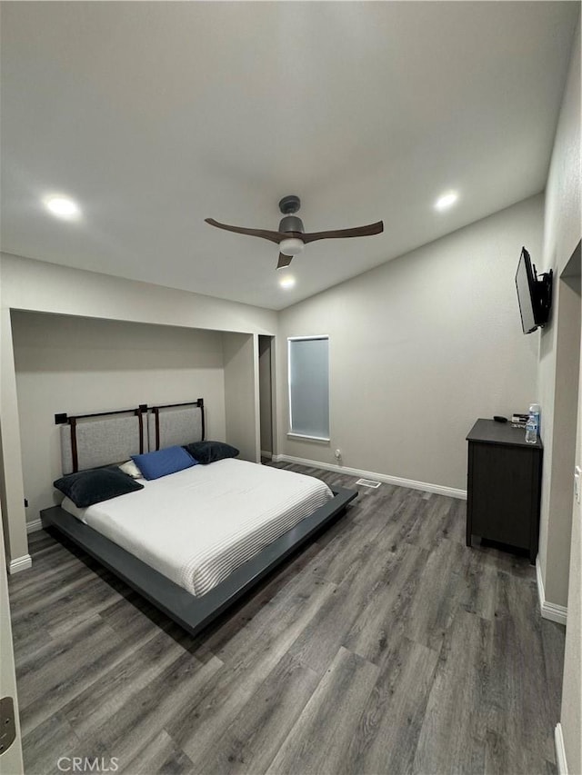 bedroom featuring ceiling fan, baseboards, and wood finished floors