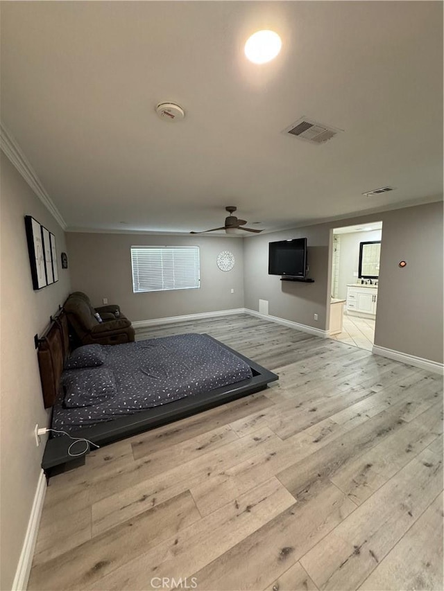 bedroom featuring wood-type flooring, visible vents, baseboards, and ornamental molding