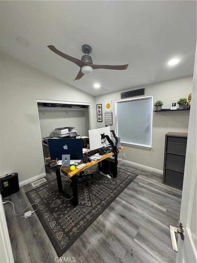 home office with lofted ceiling, visible vents, baseboards, and wood finished floors