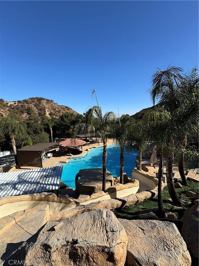 community pool featuring a patio and a mountain view