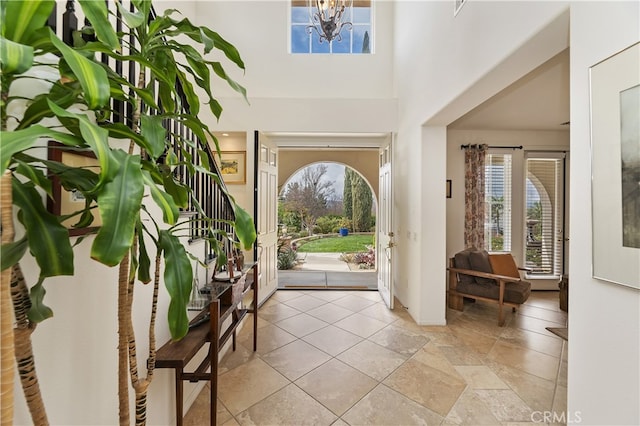 entrance foyer with an inviting chandelier and a towering ceiling