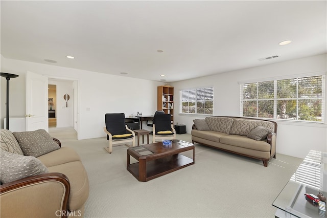 carpeted living area with recessed lighting and visible vents