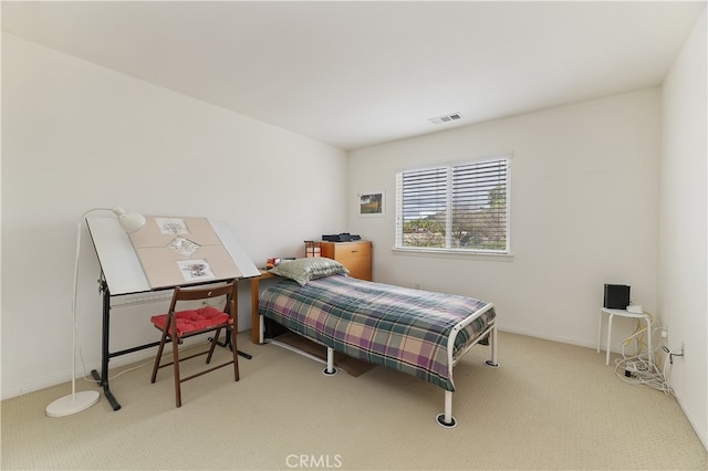 carpeted bedroom with visible vents and baseboards