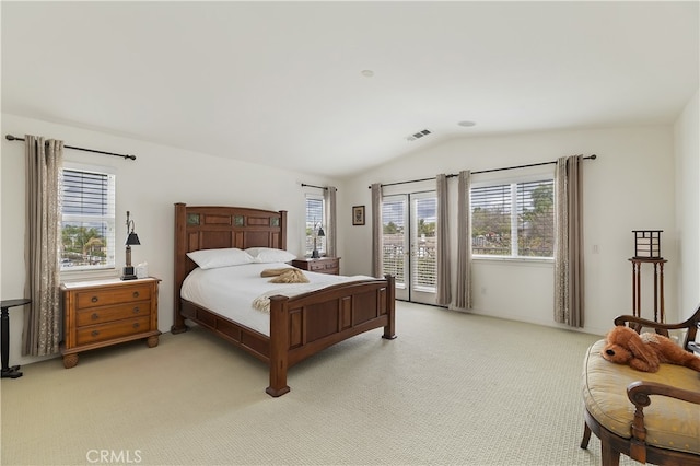 bedroom with vaulted ceiling, access to outside, multiple windows, and visible vents