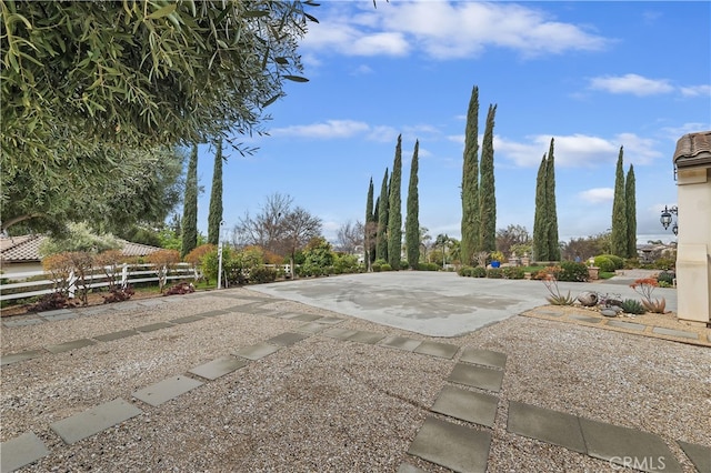 view of yard featuring driveway and fence