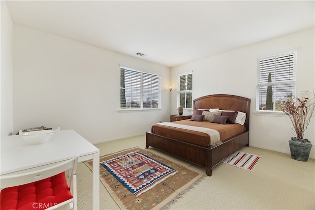 bedroom with visible vents, baseboards, and carpet