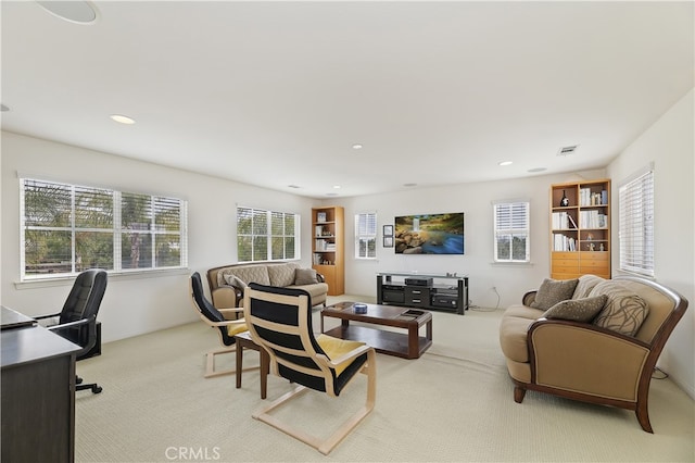 living area with carpet flooring, recessed lighting, and visible vents