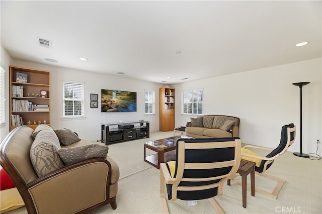 living room featuring recessed lighting, visible vents, and light carpet