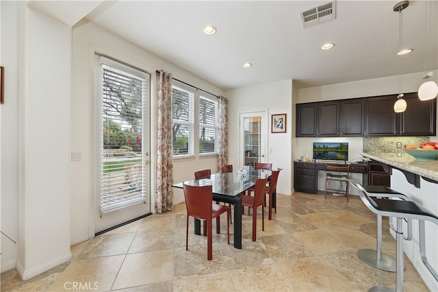 dining area featuring recessed lighting, visible vents, and stone finish flooring