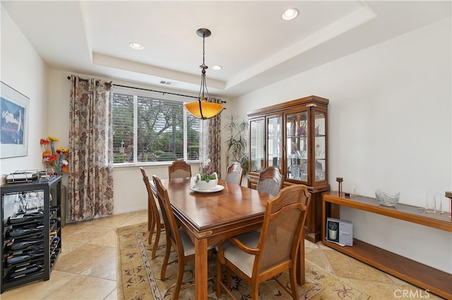 dining room with recessed lighting, visible vents, and a raised ceiling