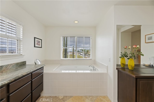 full bathroom featuring vanity and a garden tub