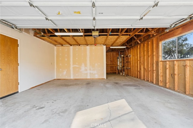 garage featuring gas water heater and a garage door opener