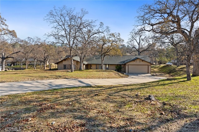 view of front of home featuring a garage, concrete driveway, and a front lawn