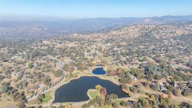 drone / aerial view featuring a water and mountain view