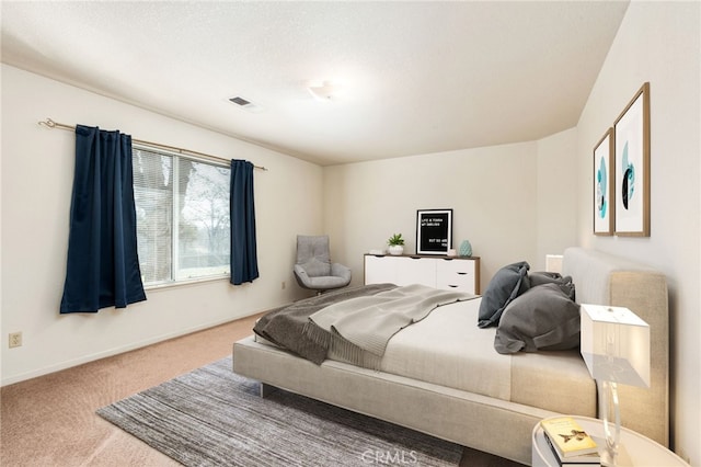 carpeted bedroom with baseboards and visible vents