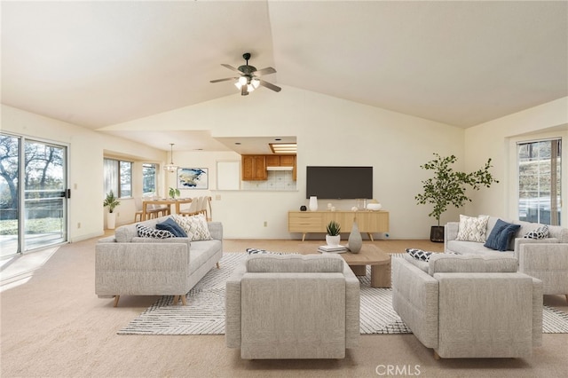 living area featuring lofted ceiling, light carpet, and ceiling fan