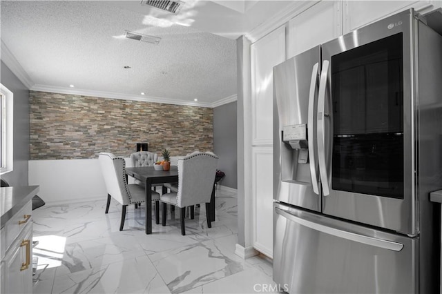 18218 Otilla St, Bloomington, CA 92316 - kitchen featuring a textured ceiling, white cabinets, stainless steel fridge with ice dispenser, and ornamental molding