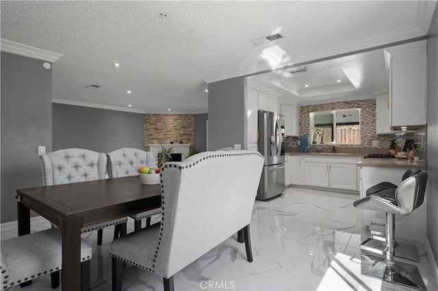 18218 Otilla St, Bloomington, CA 92316 - dining area featuring recessed lighting, a tray ceiling, a textured ceiling, and ornamental molding