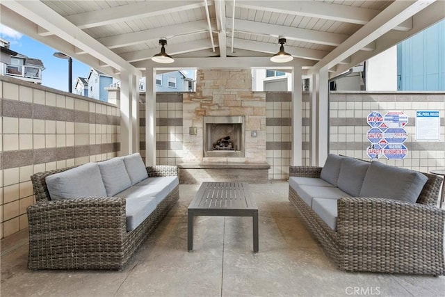 view of patio featuring an outdoor living space with a fireplace, ceiling fan, and fence