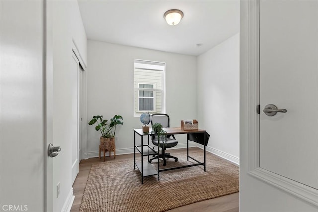 office featuring baseboards and wood finished floors