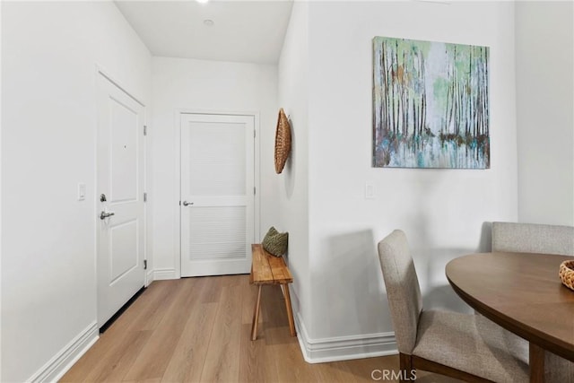 interior space featuring baseboards and light wood-style floors