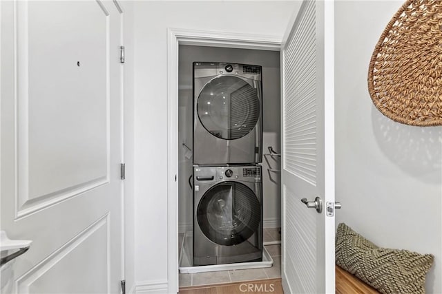 clothes washing area featuring laundry area and stacked washer / dryer