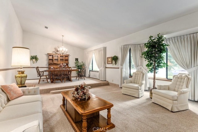 living area with an inviting chandelier, visible vents, vaulted ceiling, and light colored carpet