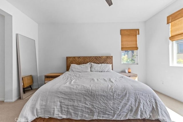 carpeted bedroom featuring ceiling fan