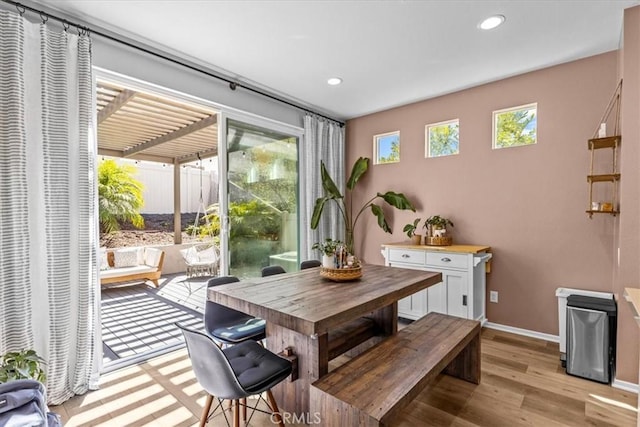 dining area with plenty of natural light, light wood-style flooring, and recessed lighting