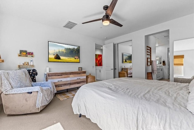 carpeted bedroom featuring connected bathroom, a closet, visible vents, and ceiling fan